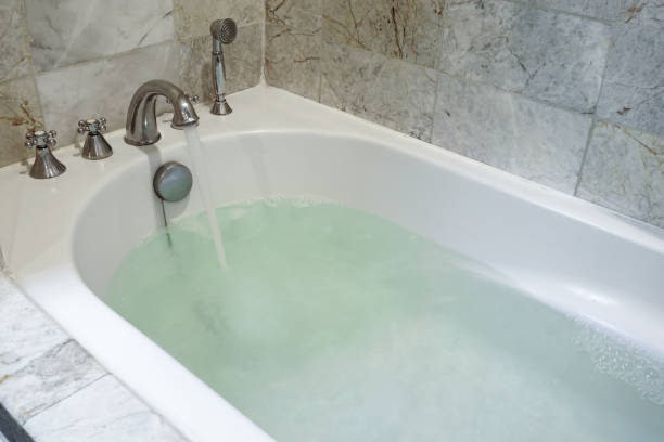 istock Stainless Faucet with white bathtub in bathroom. 1292857098
