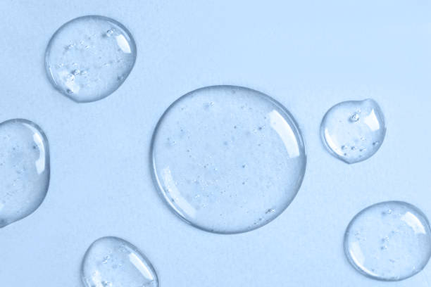 istock Drops of liquid transparent gel with bubbles on a blue background. 1292857369