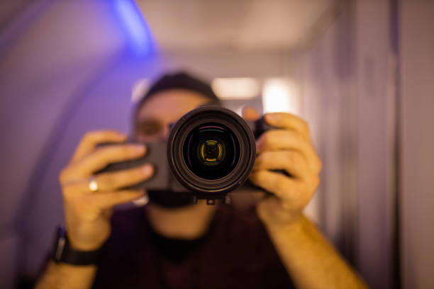 istock Man taking self-portrait inside an airplane bathroom 1292857522