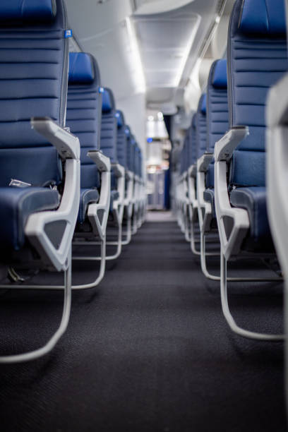 istock Empty dark blue passenger airplane seats in the cabin. 1292859317