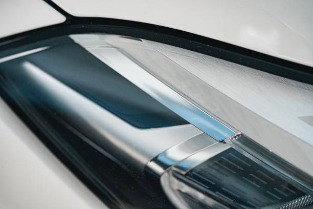 istock Headlights of a new white luxury car 1292860252