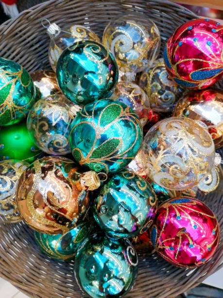 istock Multicolored and original Christmas tree decorations in a basket 1292860327