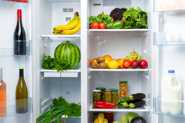 istock Open fridge full of fruits, vegetables and drinks 1292860448