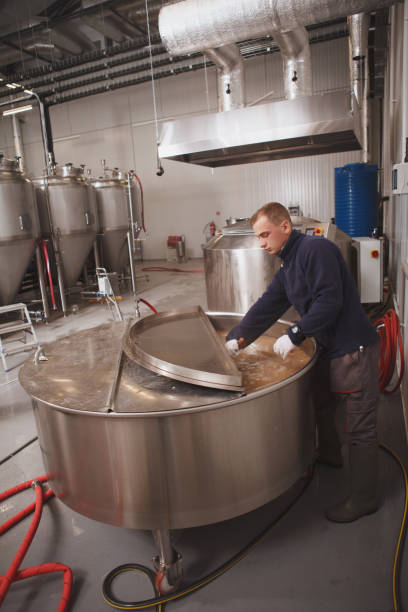 istock Brewer working at craft beer factory 1292860737