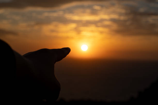 istock Happy new year orange light sky sunrise and finger 1292861817