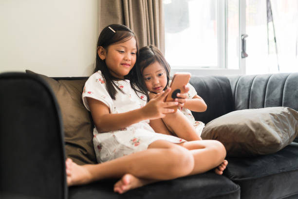 istock Two sisters on phone enjoying them self. 1292863200