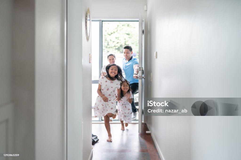 Family new home. Two sisters one younger and other older are very happy to arrived at new home in Auckland, New Zealand. Family Stock Photo