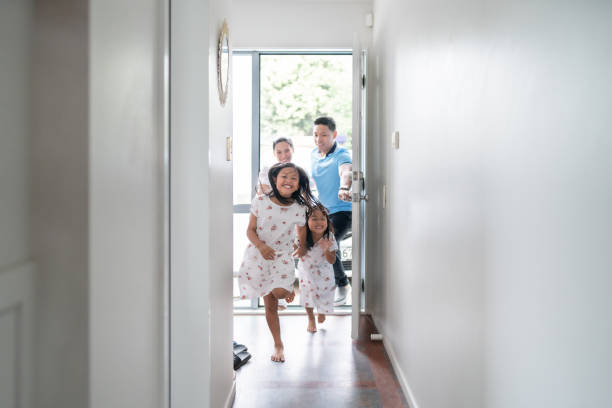 Family new home. Two sisters one younger and other older are very happy to arrived at new home in Auckland, New Zealand. asian ethnicity family stock pictures, royalty-free photos & images