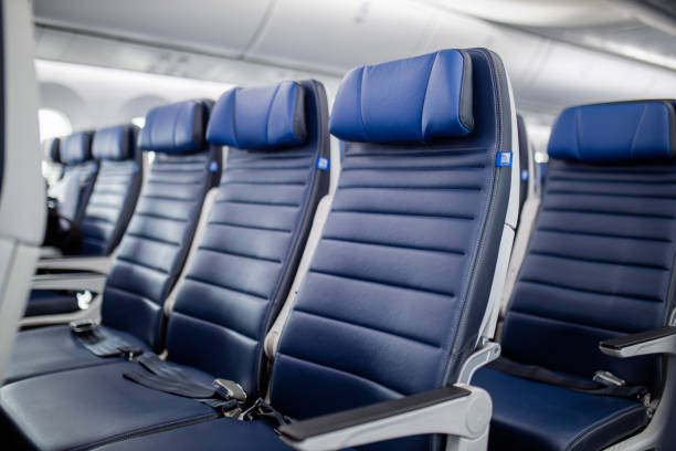 istock Dark blue passenger airplane seats in the cabin. 1292863459