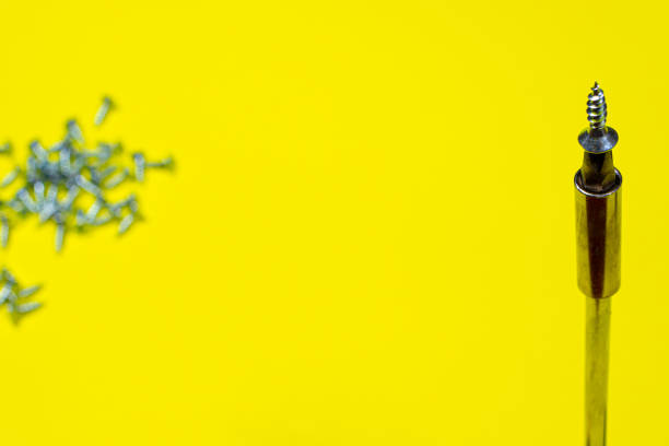 istock A set of screwdriver nozzles and a screwdriver on a yellow background with space for copyspace text. Tools for construction and repair shop 1292863621