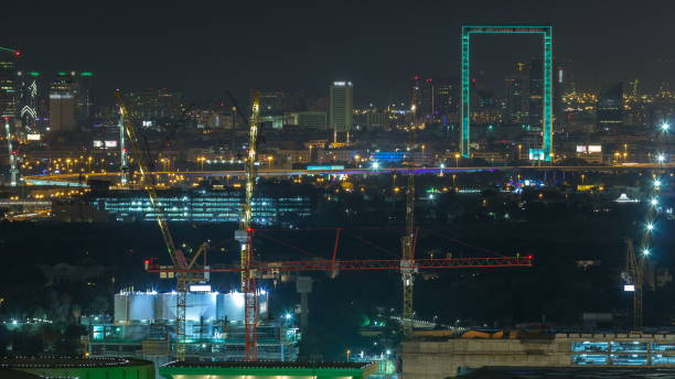 Dubai skyline night with illuminated landmarks Dubai skyline night with illuminated landmarks. Aerial top view from Dubai downtown undivided highway stock pictures, royalty-free photos & images