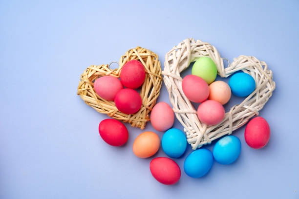 istock Colorful Easter eggs in decorative nest on blue background 1292866757