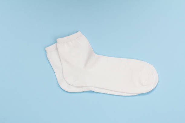 istock Pair of white women socks on blue background. 1292868255