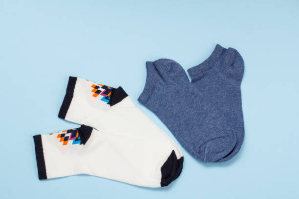 istock White and dark blue cotton women socks on blue background. 1292868982