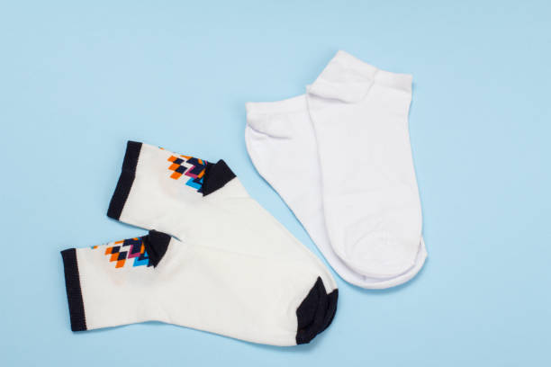 istock White cotton women socks on blue background. 1292868984