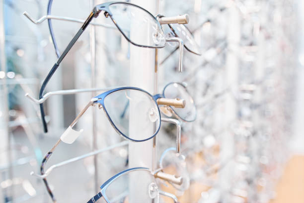 istock Eyeglasses sorted in line on shelf at optical shop 1292871313