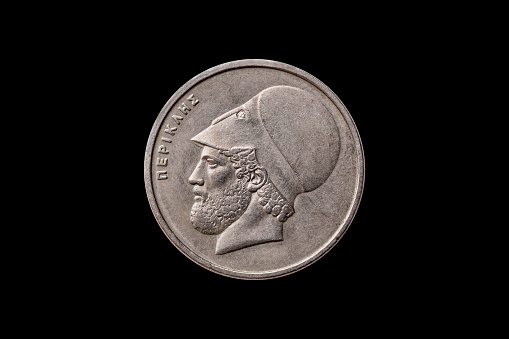 Greek 20 Drachma coin dated 1982 with a portrait image of  Pericles (495 to 429 BC) cut out and isolated on a black background, stock photo image