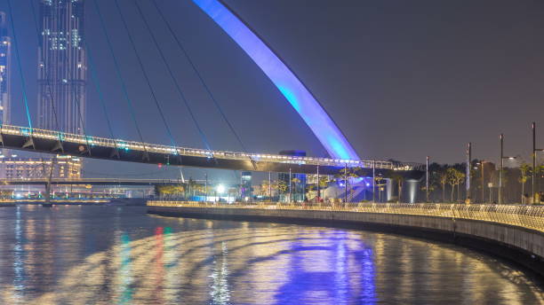 istock Futuristic Pedestrian Bridge over the Dubai Water Canal Illuminated at Night , UAE 1292876092
