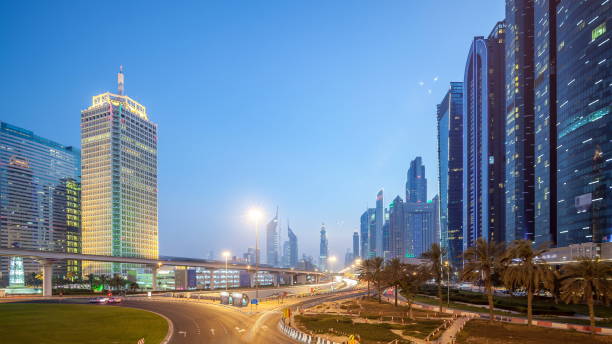 istock Traffic on intersection and bridge at the Sheikh Zayed Road day to night 1292876176