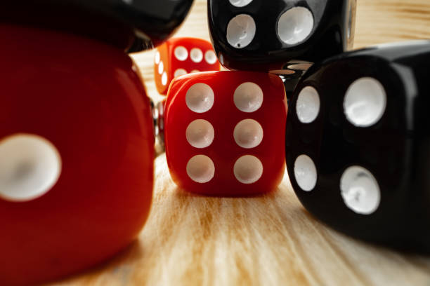 istock Red and black dice cubes on wooden background 1292876582