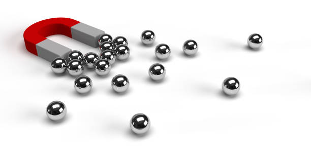 istock Silver spheres gavitated to a horseshoe magnet. 1292877294