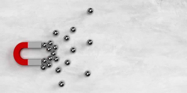 istock Silver spheres gavitated to a horseshoe magnet. 1292877323
