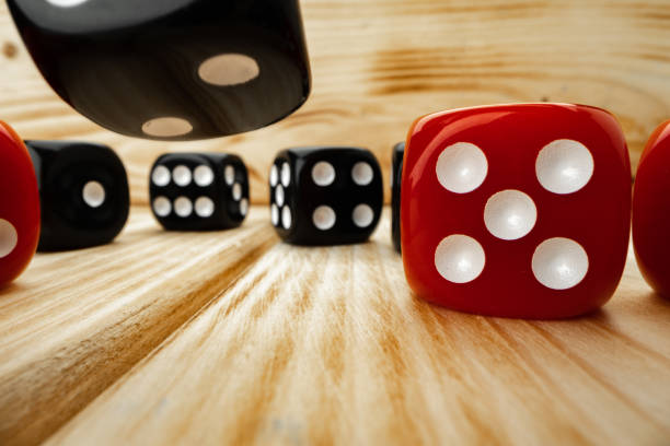 istock Red and black dice cubes on wooden background 1292877488