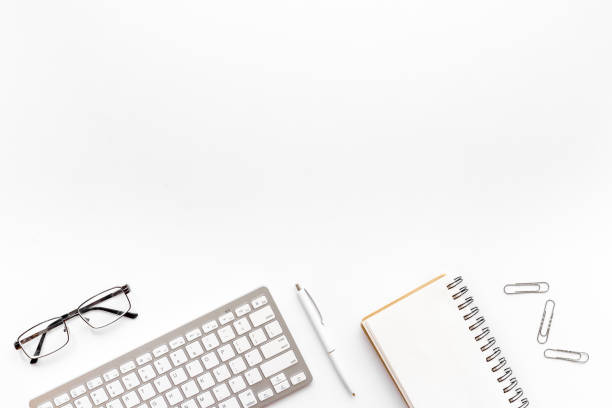 istock Office workplace flat lay background. Keyboard and office supplies top view 1292877671