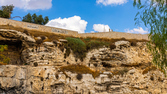 Jerusalem, Israel - October 14, 2017: Skull Hill rock escarpment - Calvary or Golgotha - considered as actual place of crucifixion of Jesus Christ near Old City of Jerusalem