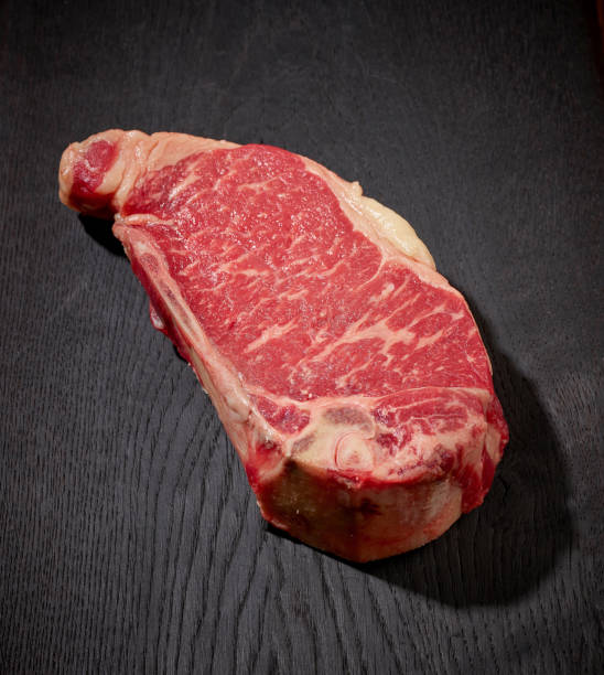 istock fresh raw beef steak meat on black wooden cutting board 1292883424