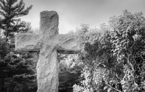 istock Black And White Cross In Cemetery 1292883466