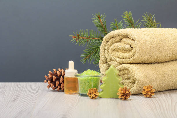istock Spa composition with soft terry towel and spa products on wooden boards 1292883649