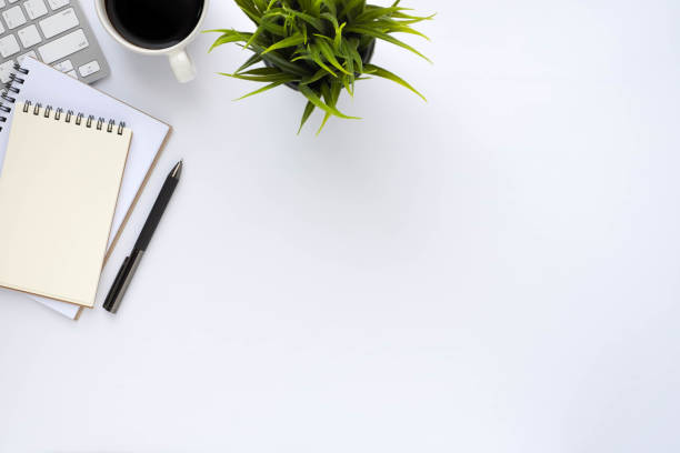 istock White office desk table with keyboard, notebook and coffee cup with equipment other office supplies. Business and finance concept. Workplace, Flat lay with blank copy space. Top view 1292884811
