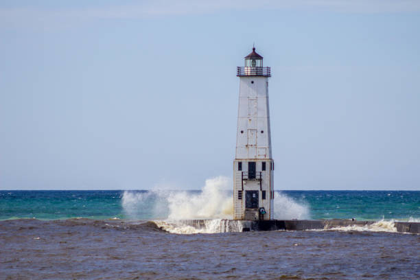 istock Waves Crash On Frankfort Michigan Lighthouse 1292886178