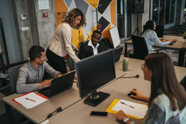 istock Manager supervising the work of employees 1292887333