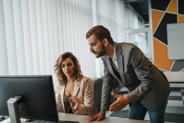 istock Male and female Office employees having argument at workplace 1292887534