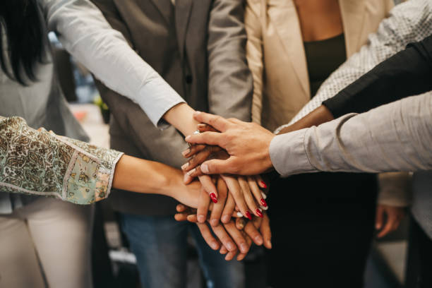 istock Happy multinational coworkers giving high five celebrating great teamwork result 1292887561