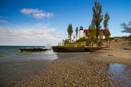 The historic Point Betsie Lighthouse on the coast of Lake Michigan on a windy day.