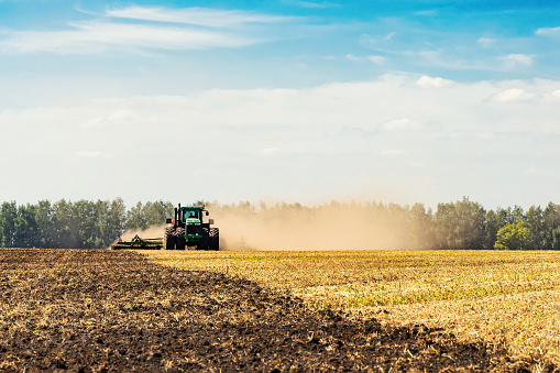 The tractor plows the land. Agriculture image.