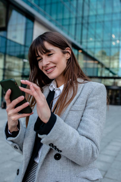istock Business women using mobile outdoors 1292888054