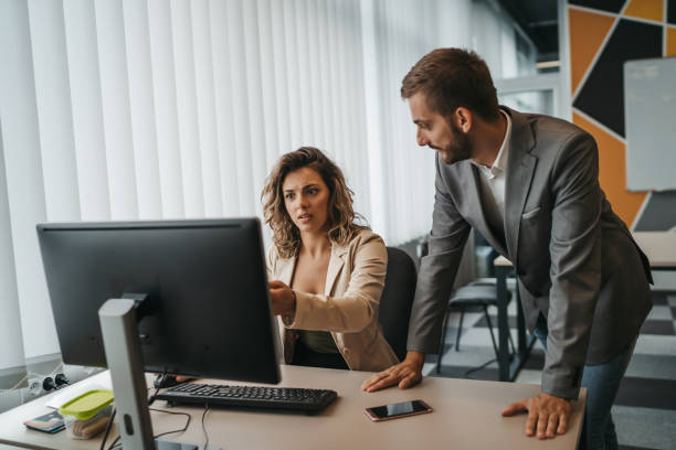 istock Male and female Office employees having argument at workplace 1292888067