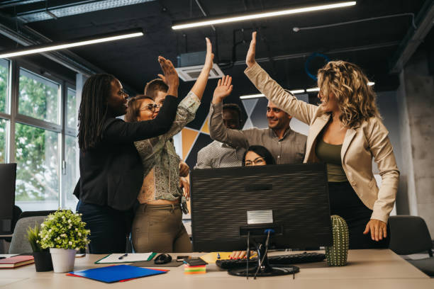 istock Happy multinational coworkers giving high five celebrating great teamwork result 1292889362