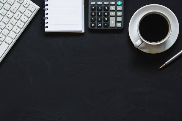 istock Top view coffee cup and object for office supply concept on black background. 1292890600