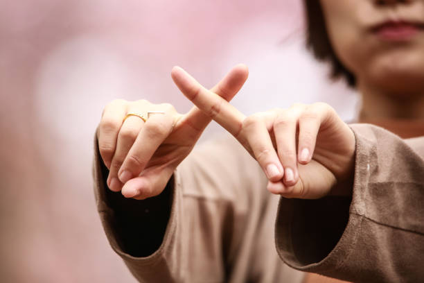 istock A woman who makes a cross by hand 1292890680