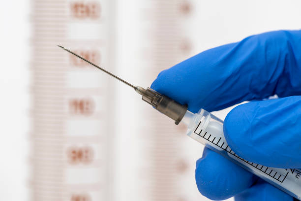 istock vaccination with serum and syringe against COVID-19 virus 1292892105