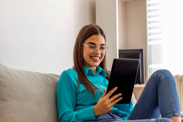 istock Smiling Caucasian woman relaxing and browsing Internet. 1292892386