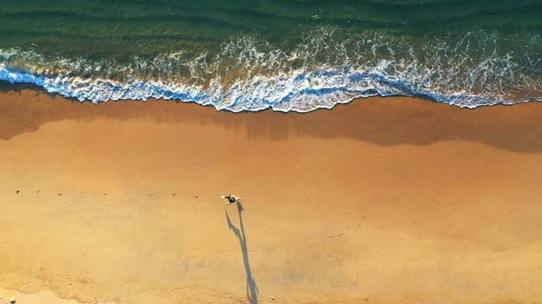 Aerial view Running woman on the Beach