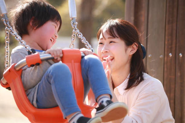 istock Parents and children playing on a swing 1292897055