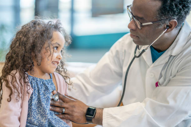 istock African American Doctor doing a checkup on a young patient 1292898290
