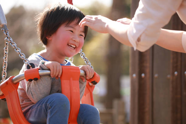 istock Parents and children playing on a swing 1292898331